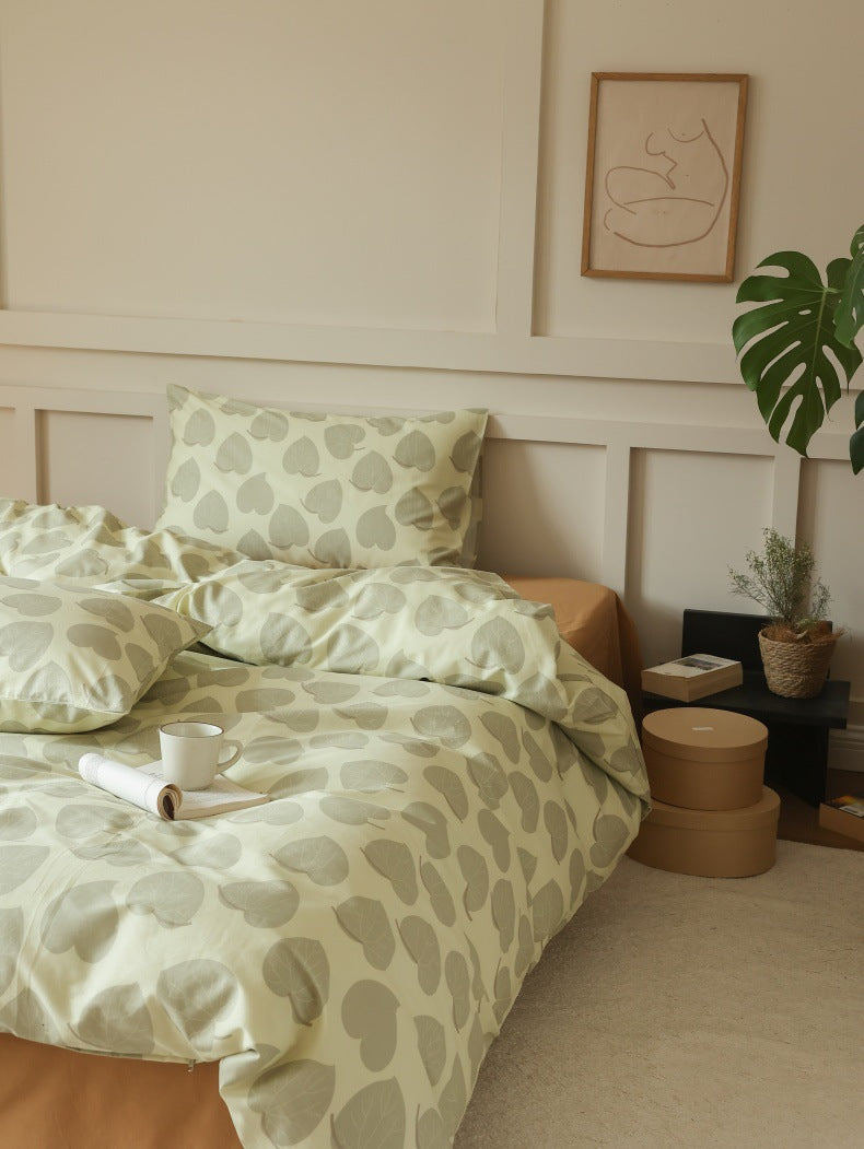 Sage Heart Leaf Cotton Bedding Set – three-quarter bed view against a paneled wall - Roomden