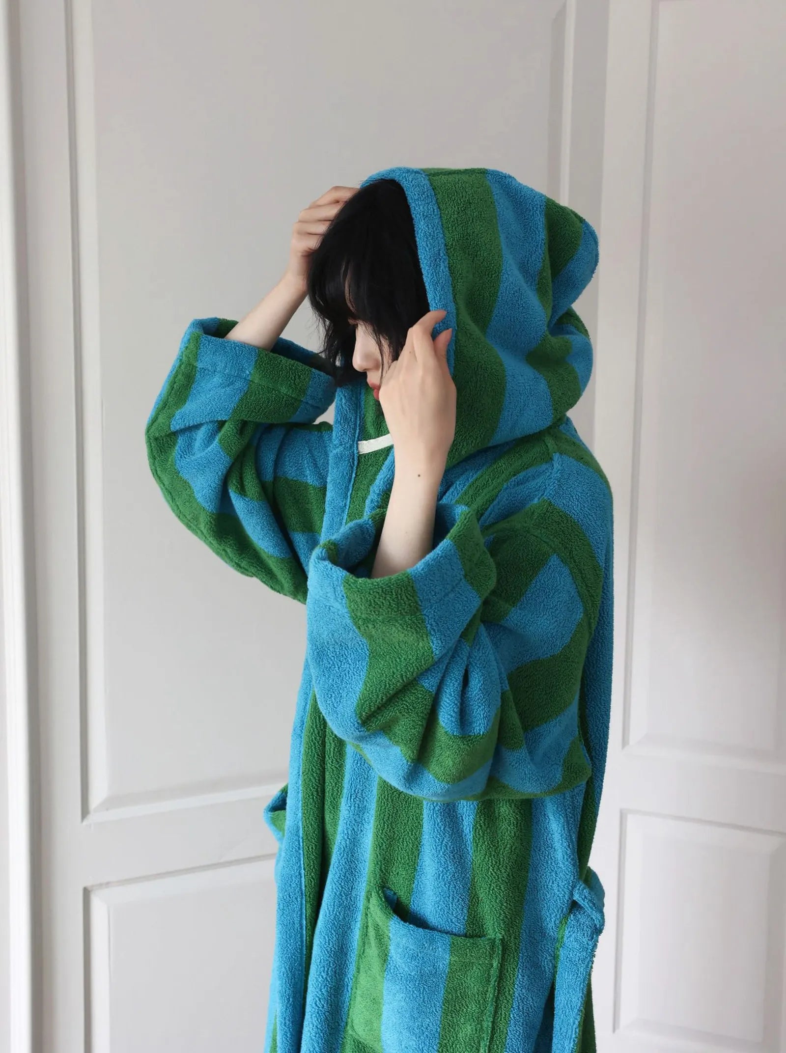 Three-quarter view of the retro style striped robe, showcasing the cozy texture - RoomDen