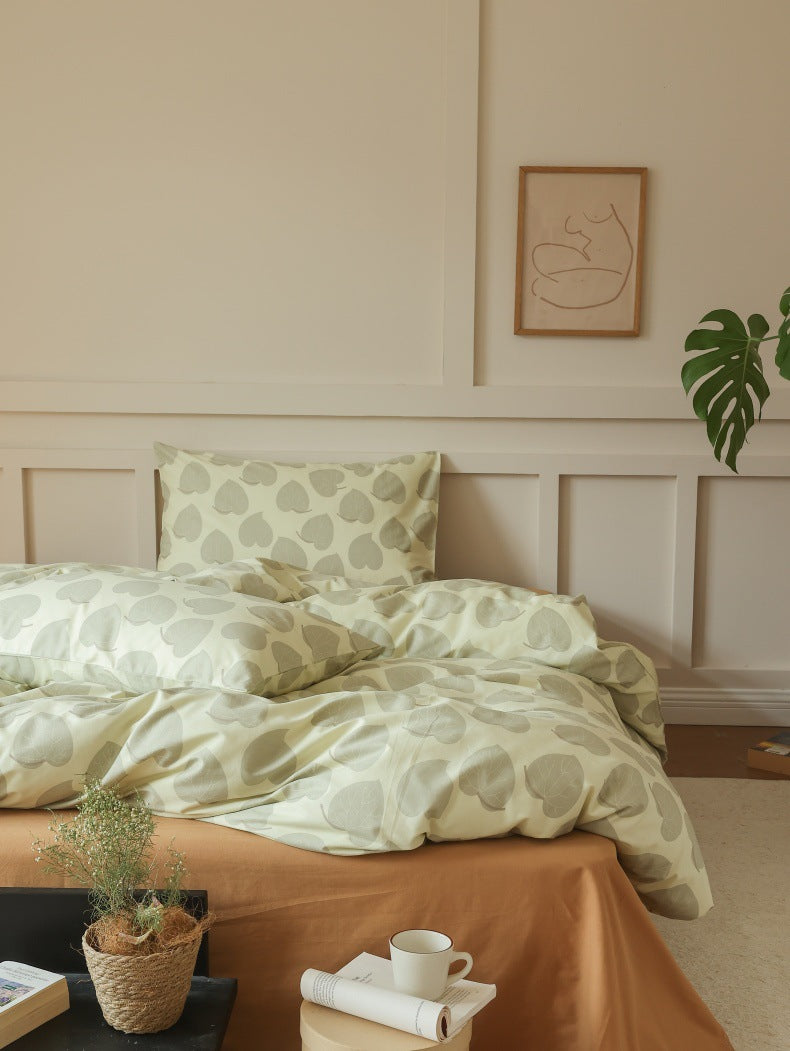 Sage Heart Leaf Cotton Bedding Set – room view with a low table at the foot of the bed - Roomden