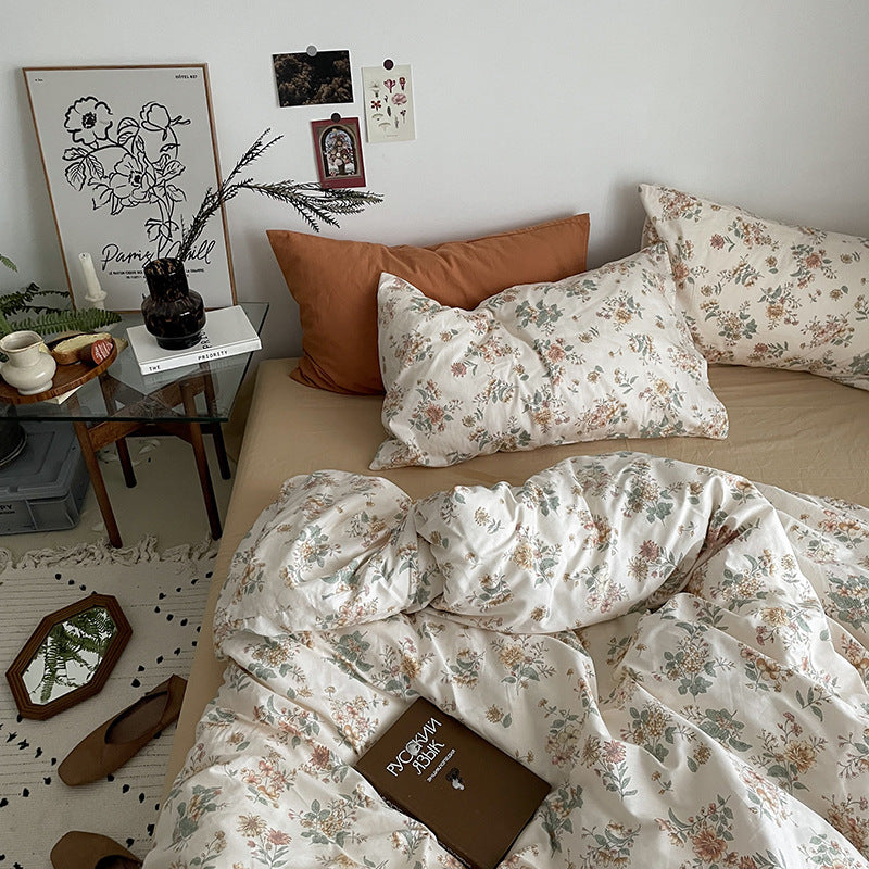 Florhaven Autumn Bouquet cotton bedding set – overhead view of floral bedding with rust pillow - Roomden