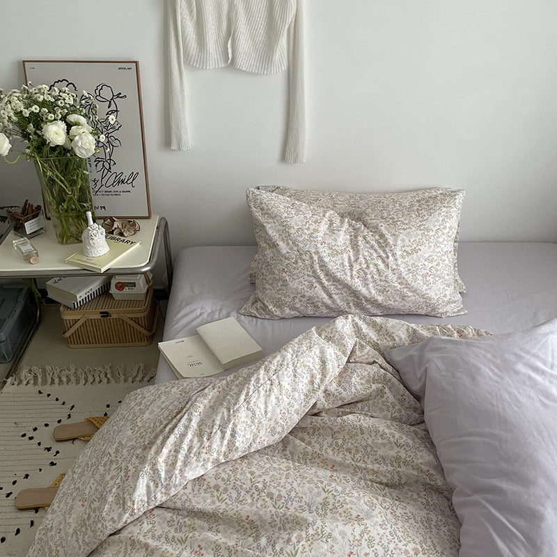 Ivory miniature meadow cotton bedding – side view showing the floral pillow and folded cover - Roomden