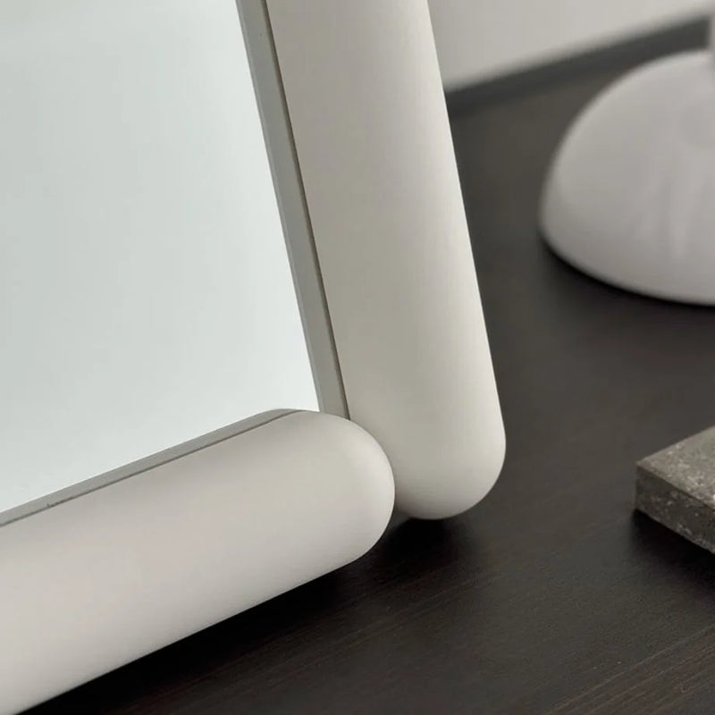 Detail of the smooth rounded corner of the white melamine mirror frame — RoomDen