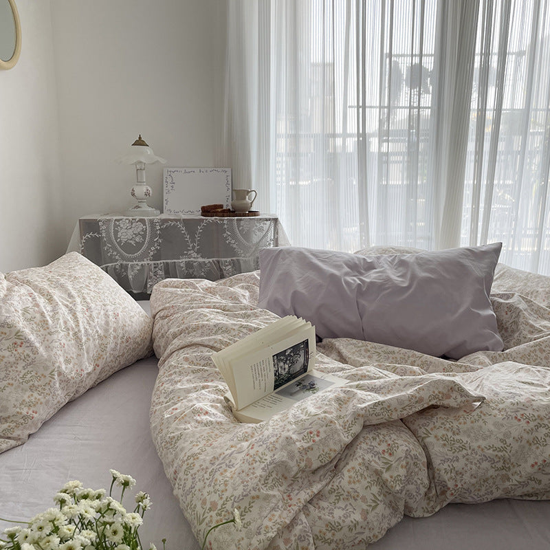 Ivory miniature meadow cotton bedding – window-side view of the floral duvet in relaxed folds - Roomden