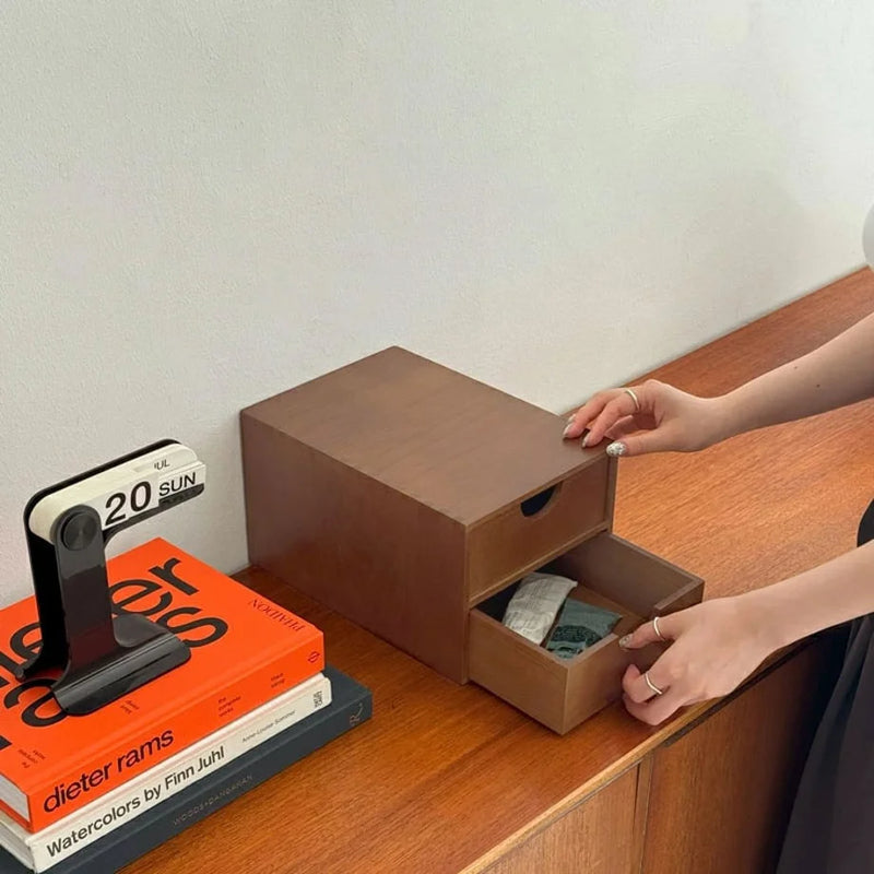 A hand opening a drawer of the wooden desktop organizer to reveal small folded items kept neatly out of sight. - RoomDen