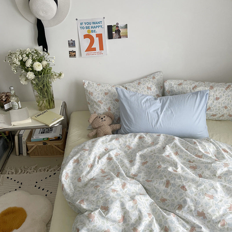 Pastel woodland cotton bedding – front view of the woodland print and light blue pillow - Roomden