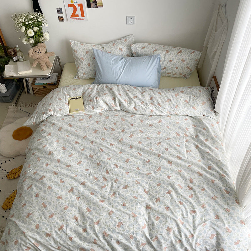 Pastel woodland cotton bedding – overhead view of the animal print duvet and light blue pillow styling - Roomden