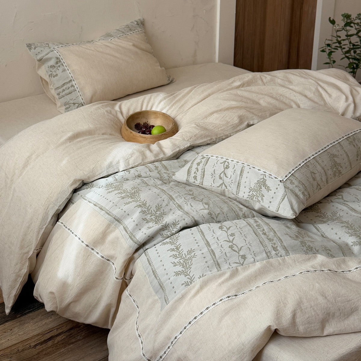 Meriwyn Botanical Linen-Cotton Bedding Set – natural reverse of the duvet turned back over sage patterned fabric - Roomden