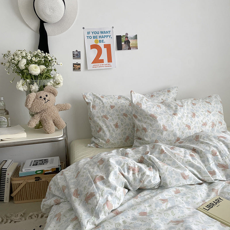Pastel woodland cotton bedding – closer bed view with matching animal print pillowcases - Roomden
