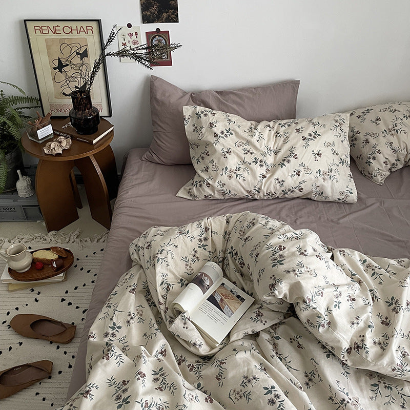Florhaven Ink Sprig cotton bedding set – angled view of the botanical duvet and coordinated pillows - Roomden