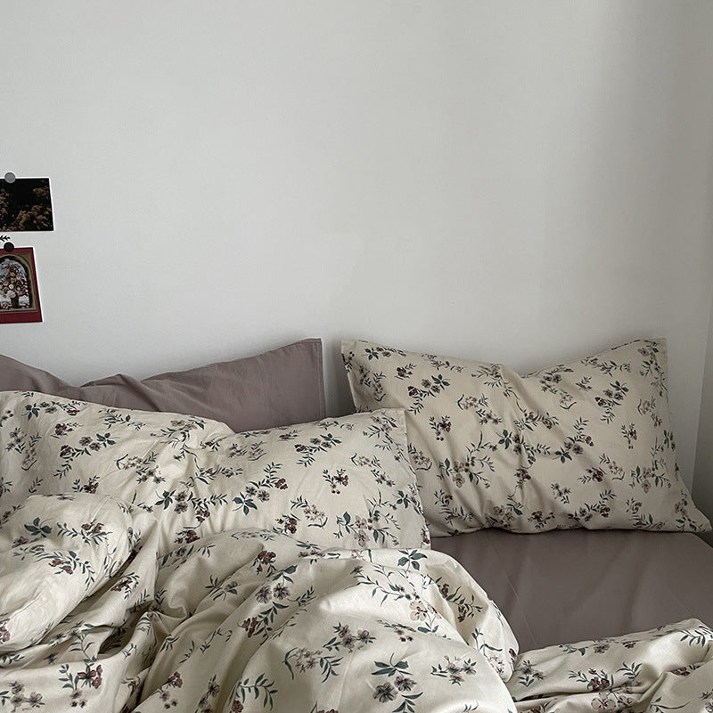 Florhaven Ink Sprig cotton bedding set – close view of botanical pillows and duvet folds - Roomden
