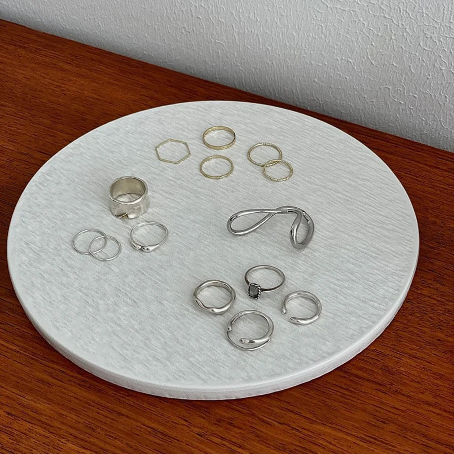 Another angle of the small textured ceramic trinket tray with an assortment of minimalist rings. - RoomDen