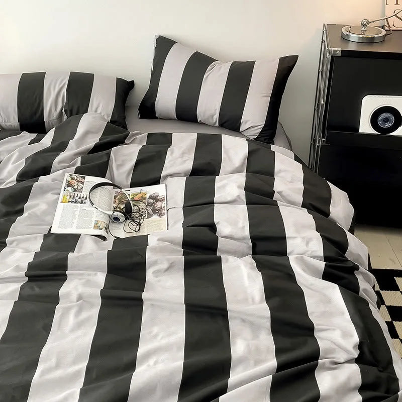 Soft Bold Stripe Cotton Bedding Set in Black & Grey on a bed in a minimalist setting - RoomDen