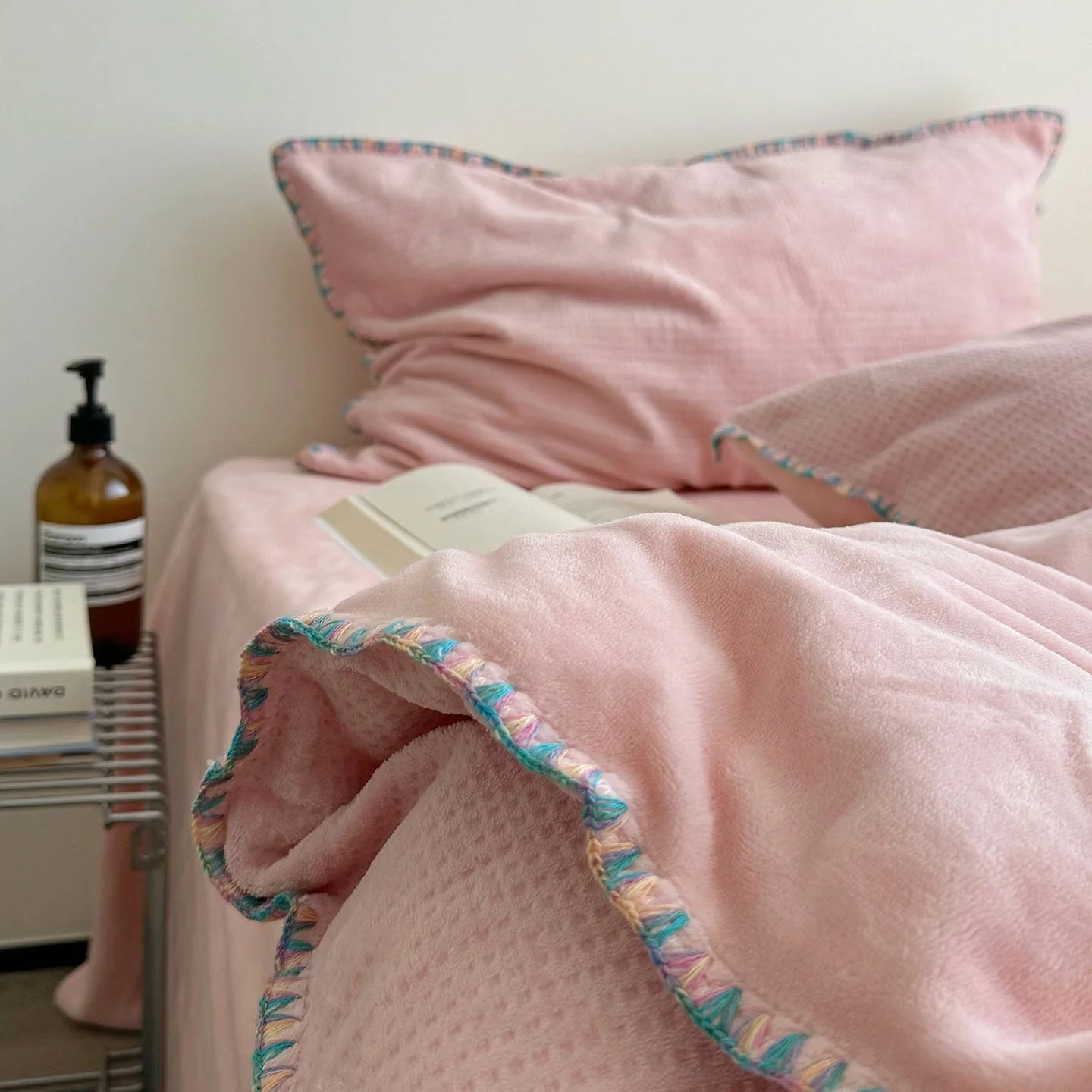 Close-up of the delicate crochet trim on the edge of the Blush Pink flannel fleece duvet cover.