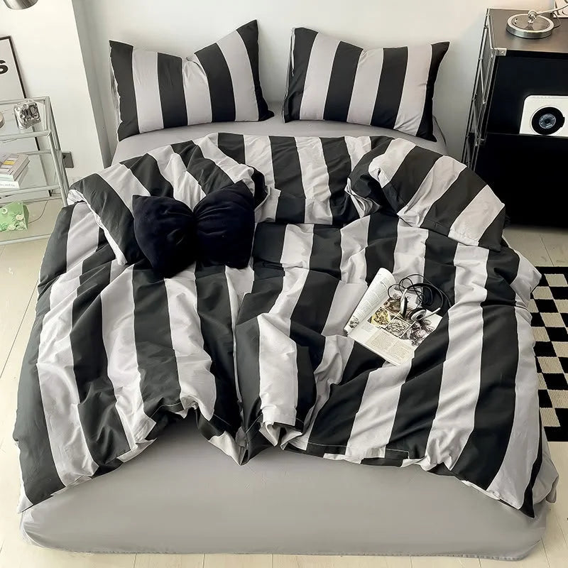 Full bed view of the Black & Grey Striped Bedding Set with a checkered rug and modern nightstand - RoomDen