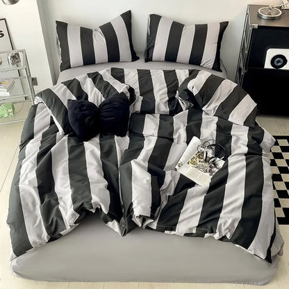 Full bed view of the Black & Grey Striped Bedding Set with a checkered rug and modern nightstand - RoomDen