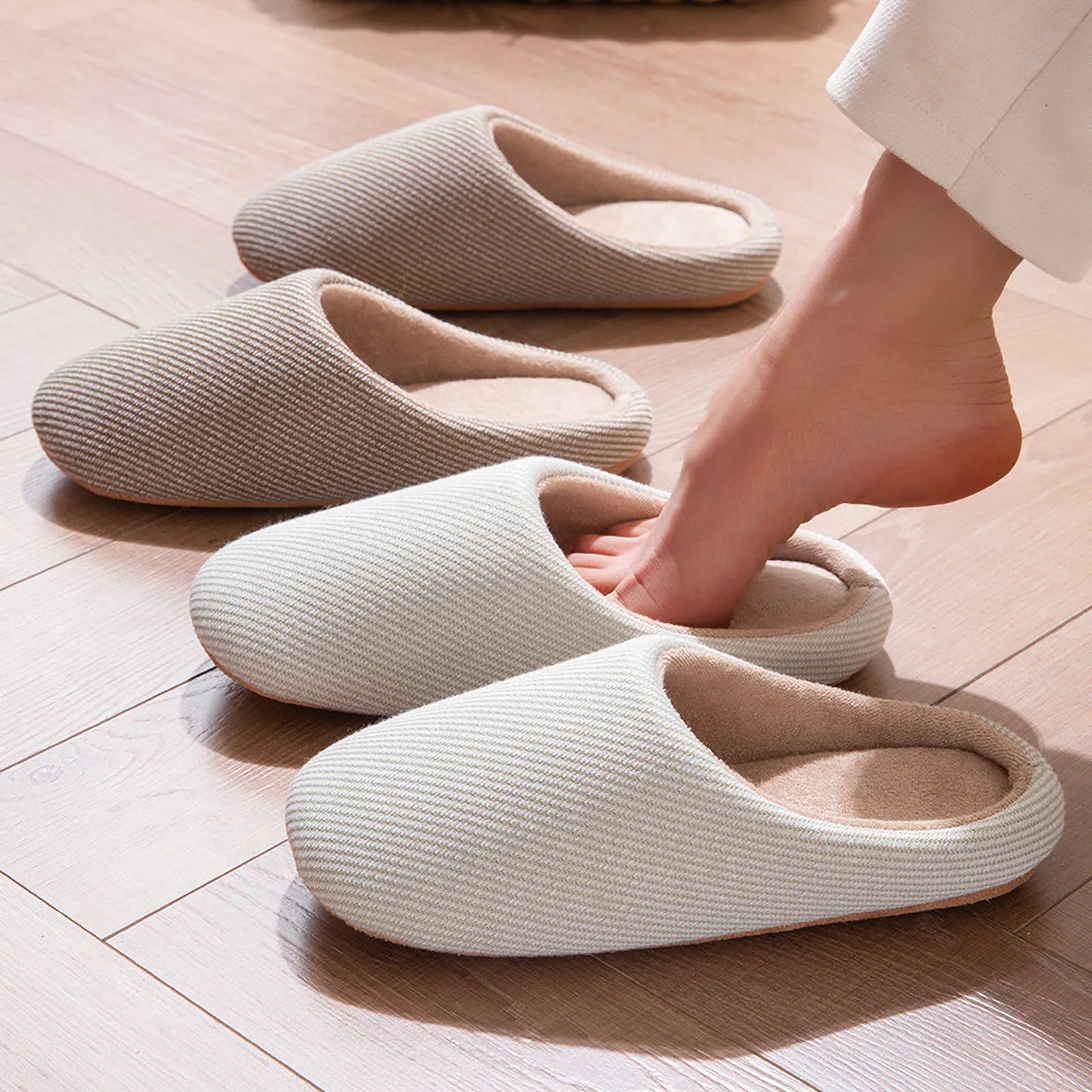 Neutral color slippers collection grey white beige on floor roomden