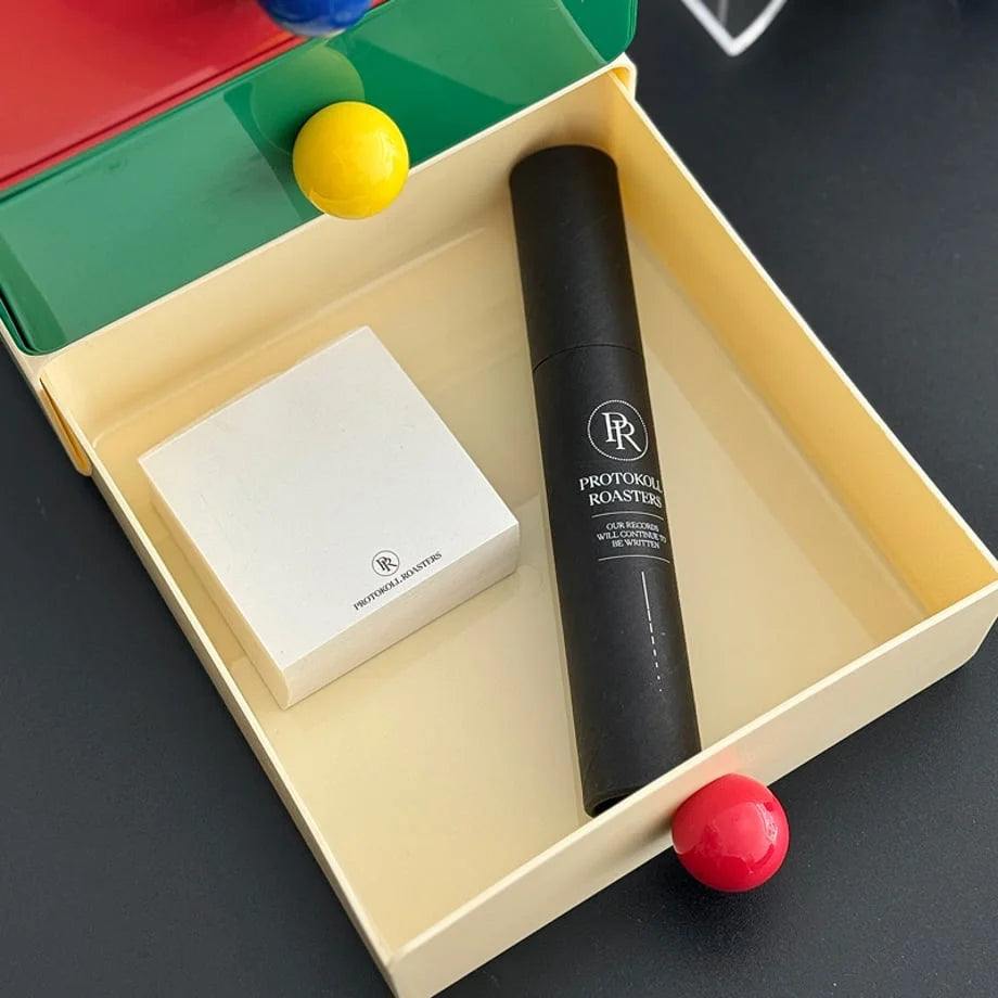 The beige desk drawer opened to show stationery and a small tube stored inside. - RoomDen