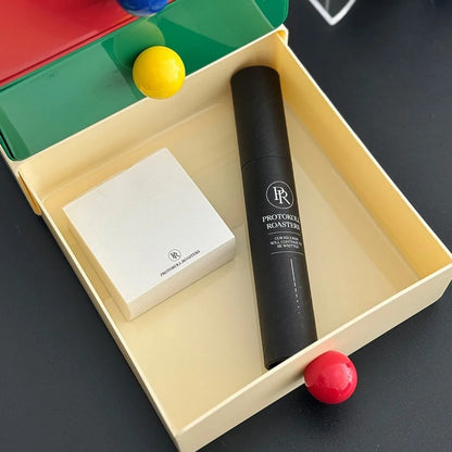 The beige desk drawer opened to show stationery and a small tube stored inside. - RoomDen