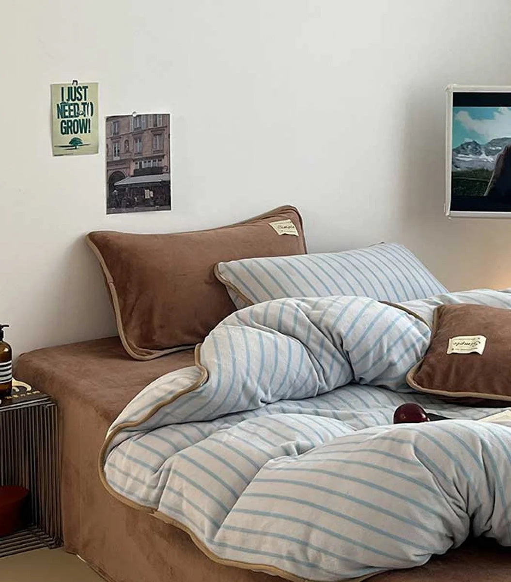 Main image of the Cozy Striped Flannel Fleece Bedding Set in Mocha Brown and Blue, styled on a bed. - RoomDen