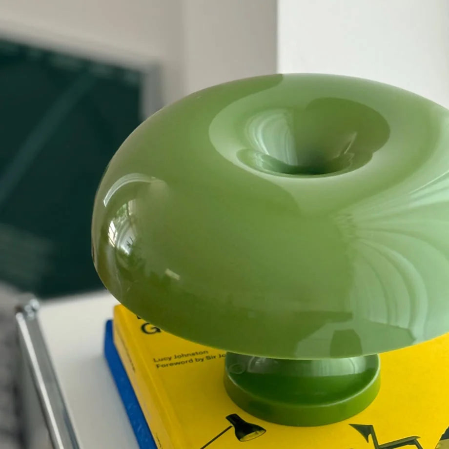Top-down close-up of the glossy lime green mushroom lamp's unique donut-hole top - RoomDen.