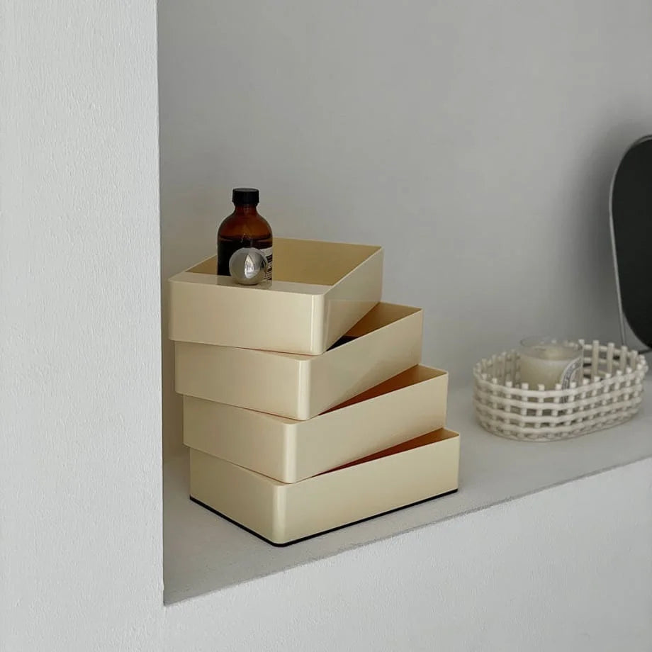 The Cream Beige organizer shown in a swiveled, open position on a minimalist shelf.