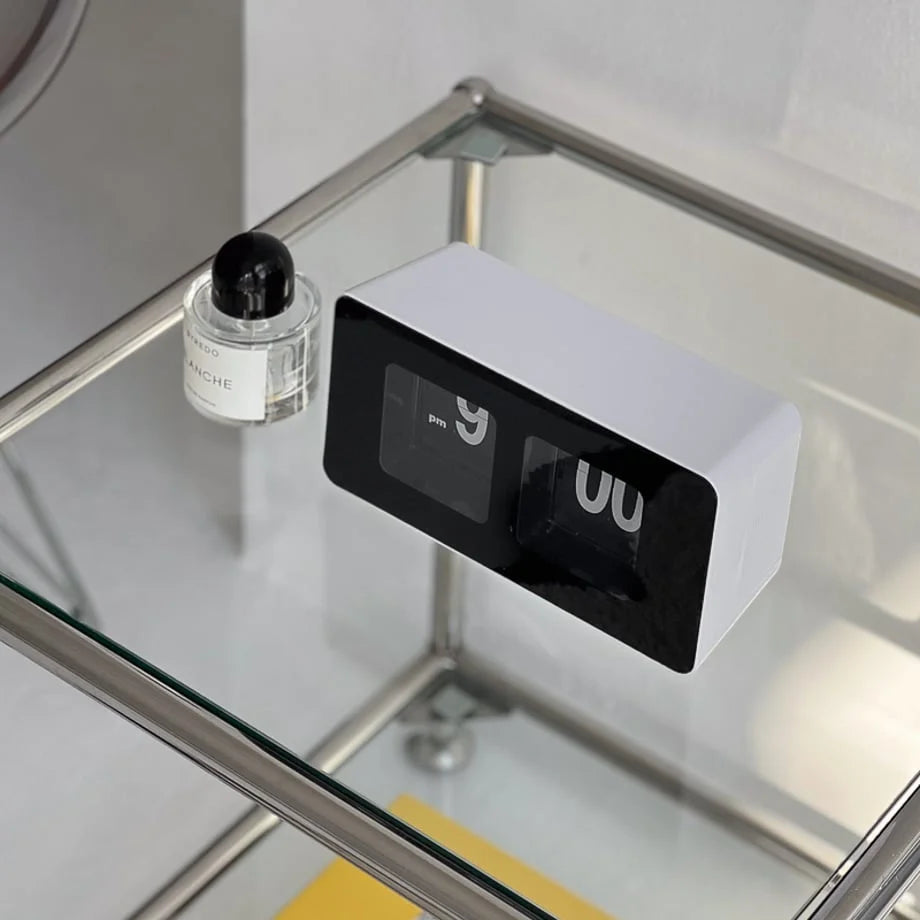 Top-down view of the black and white retro flip clock on a glass surface. - RoomDen