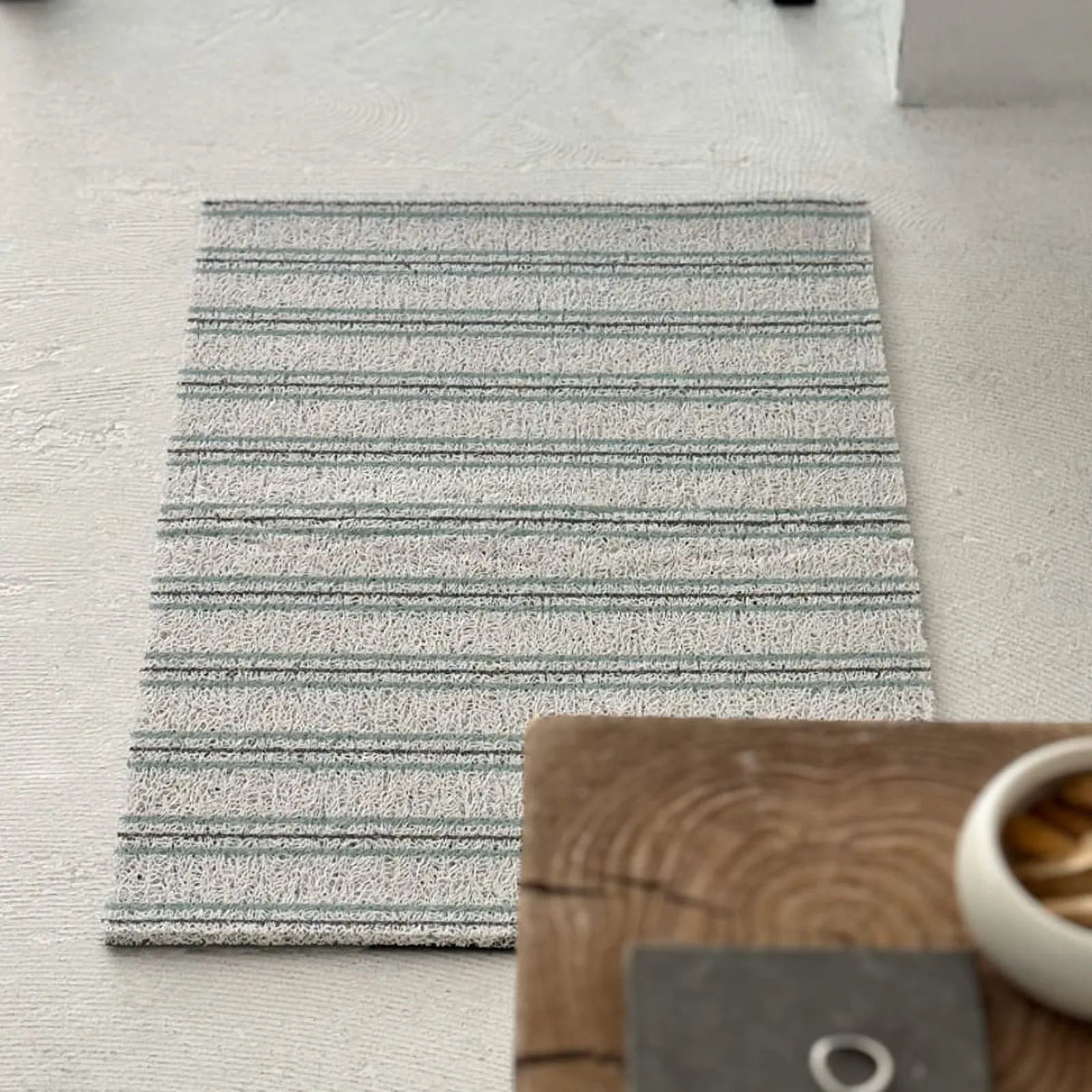 Top down full view of blue and grey striped PVC coil rug - RoomDen