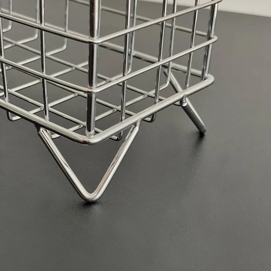 Close-up on the v-shaped metal foot of the Wireframe Grid Desktop Organizer. - RoomDen