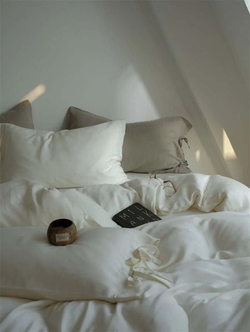 Close-up of the Creamy White Tencel duvet cover, showing its soft texture and a decorative bowl - RoomDen