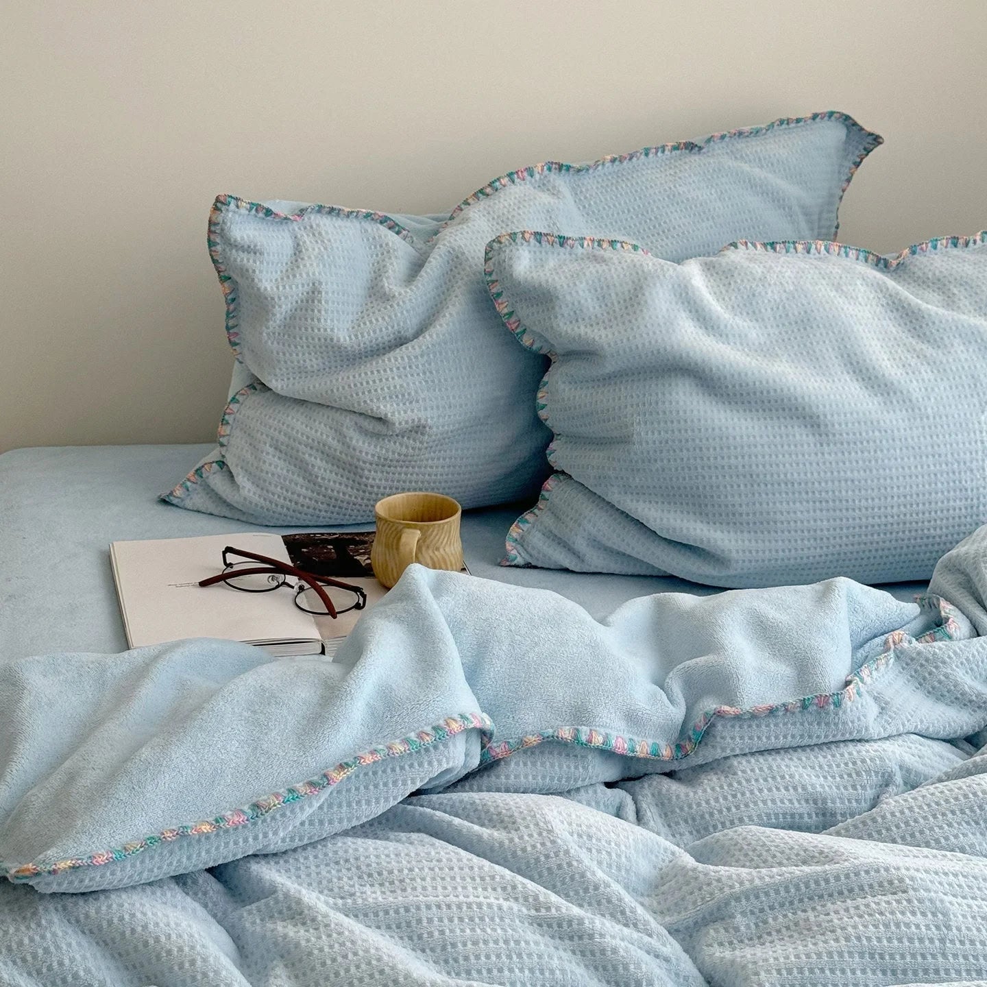 Close-up of the plush Sky Blue Waffle Fleece pillowcases, showing their soft and cozy appearance.