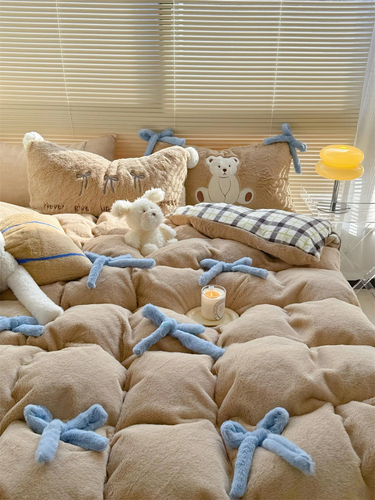 Lifestyle shot of the Khaki Brown Bear bedding with a plush white toy and candle.