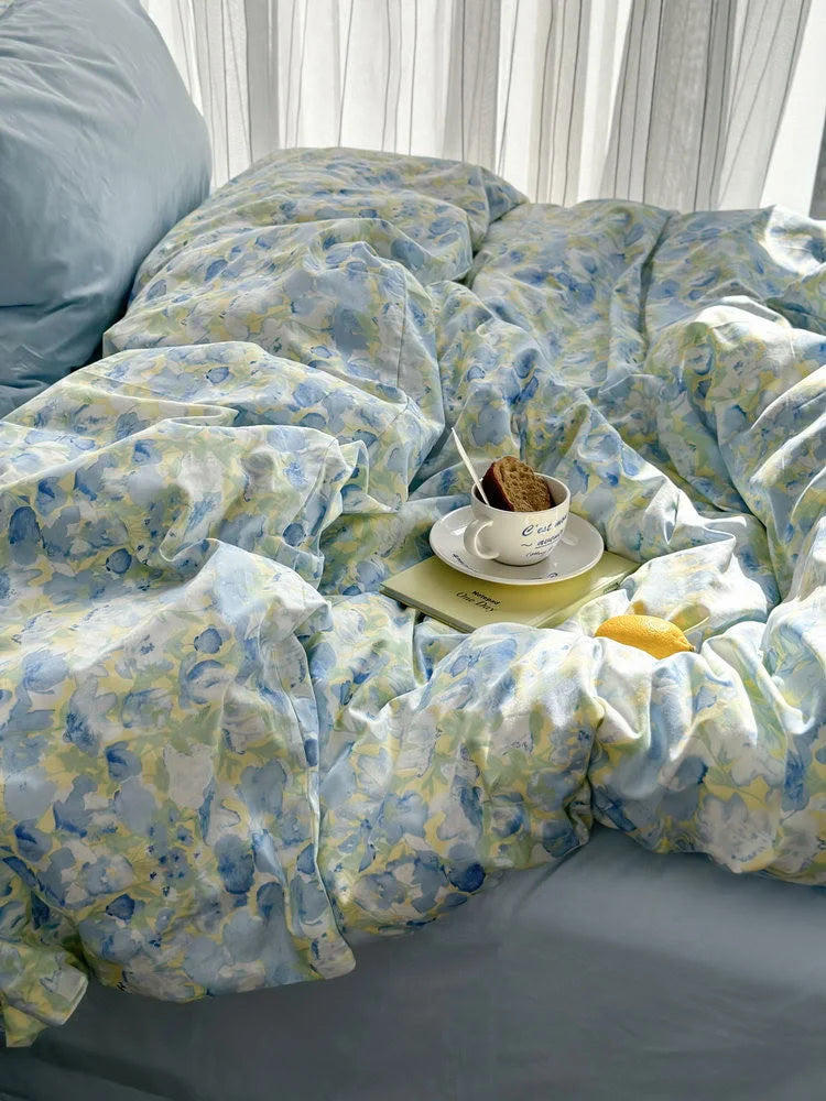 Angled shot highlighting the beautiful drape and soft folds of the watercolor floral duvet cover.