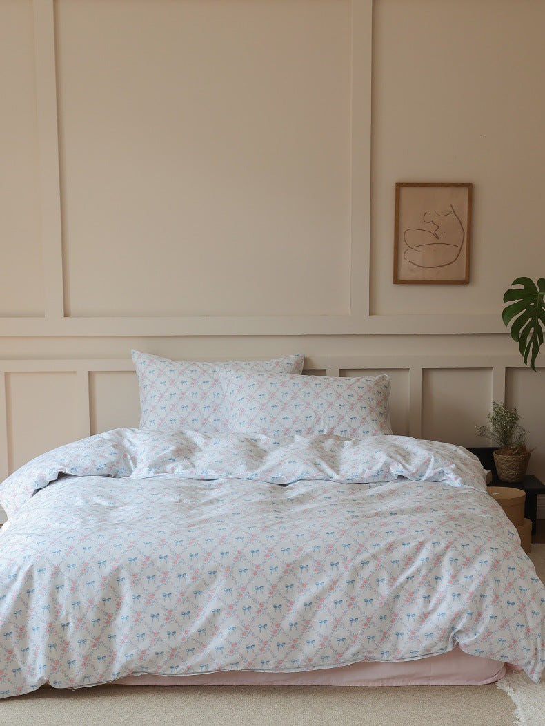 Ivory Blue Bow Rose Cotton Bedding Set – full bed against a pale paneled wall - Roomden