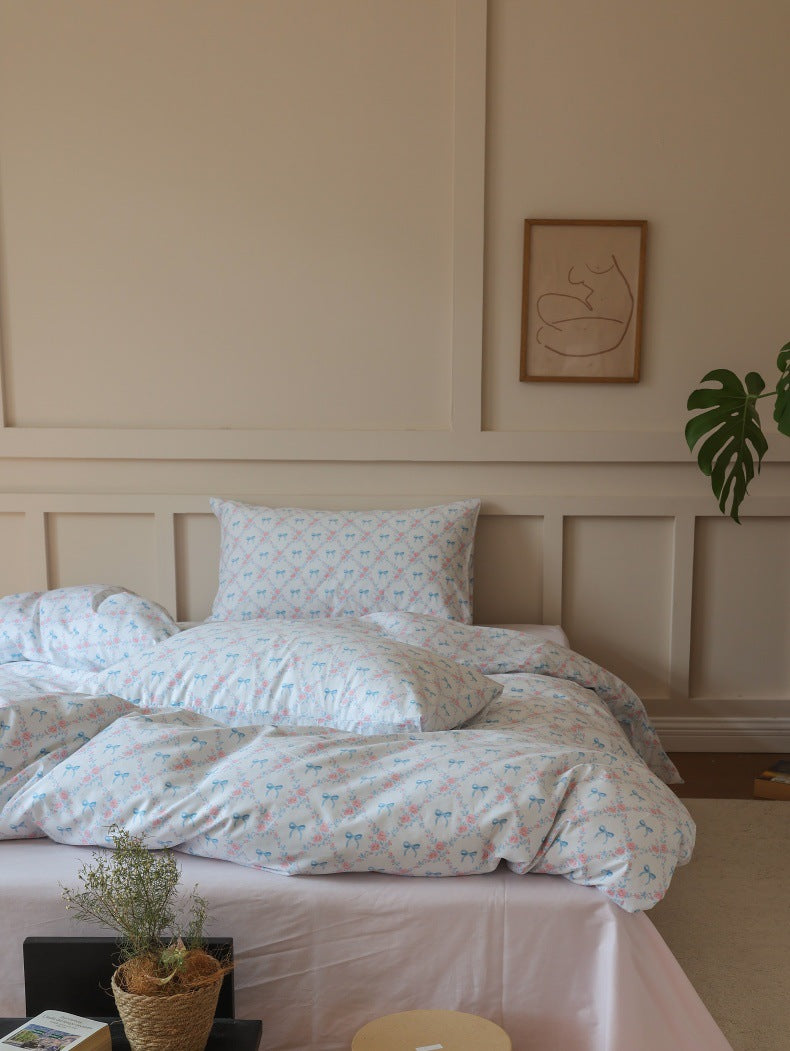 Ivory Blue Bow Rose Cotton Bedding Set – frontal room view with a low table - Roomden