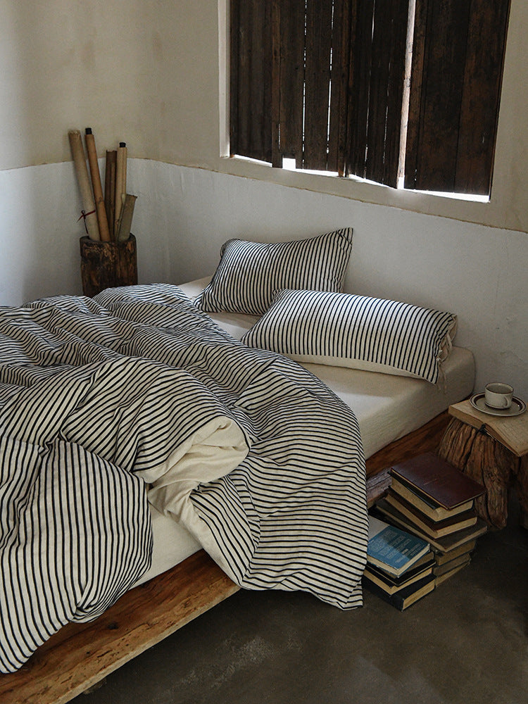 Ashfield Black Pinstripe Bedding Set – Full view of black pinstripe bedding beside a window - Roomden