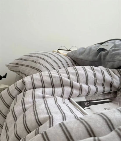 Side View of Grey Striped Plush Bedding Set on Bed