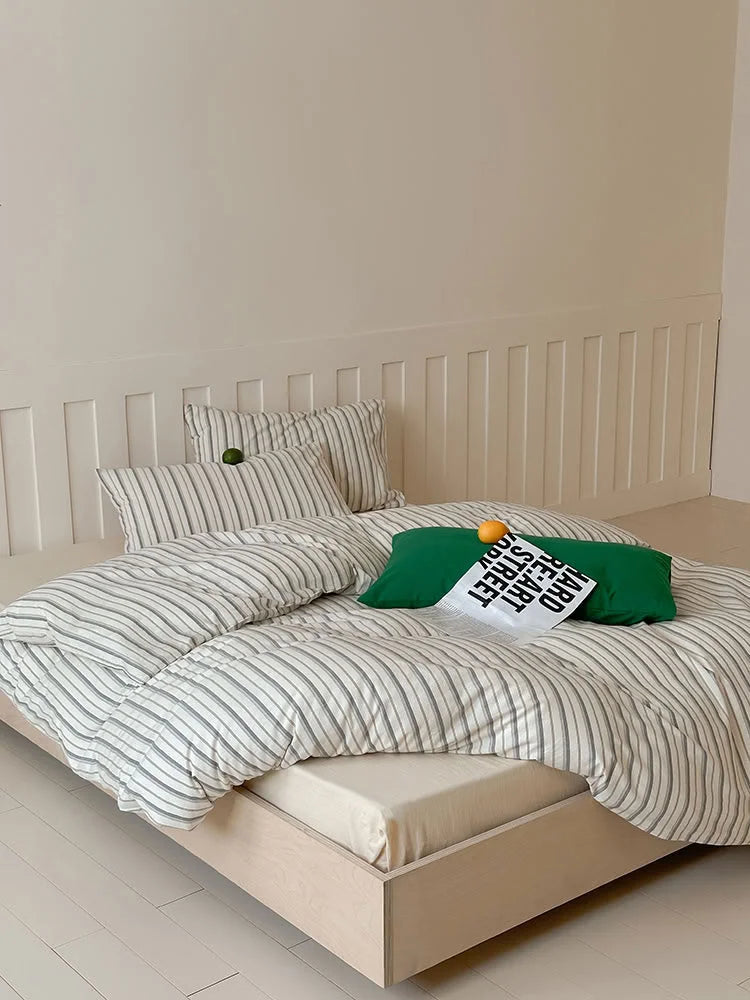 Full view of the Grey Striped Washed Cotton Bedding Set on a low-profile wooden bed in a minimalist room. - RoomDen