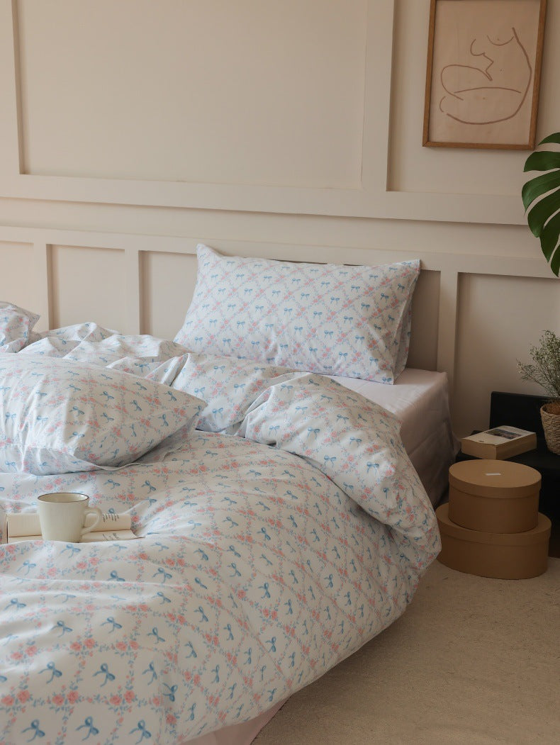 Ivory Blue Bow Rose Cotton Bedding Set – three-quarter bed view with matching pillows - Roomden