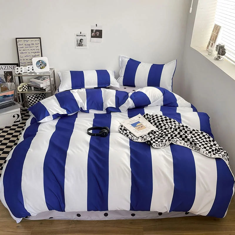 Indie dorm room featuring the Blue & White Bold Stripe Bedding Set with posters and a modern clock - RoomDen