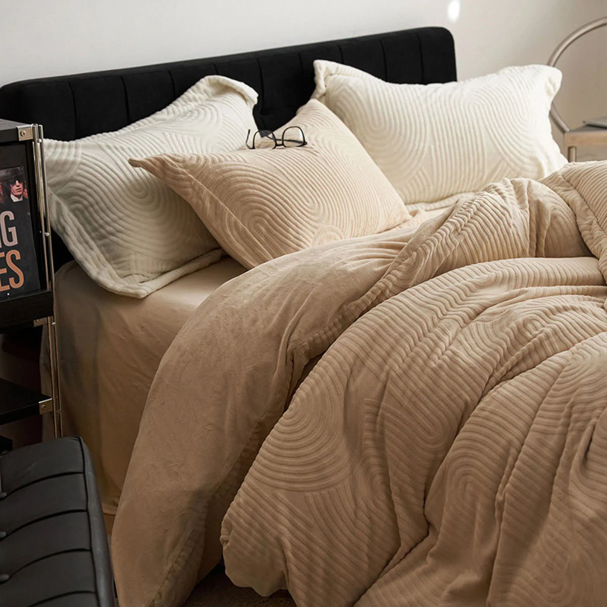 Close-up of the Latte Beige flannel fleece bedding, showing the texture and warm color against a black headboard. - RoomDen