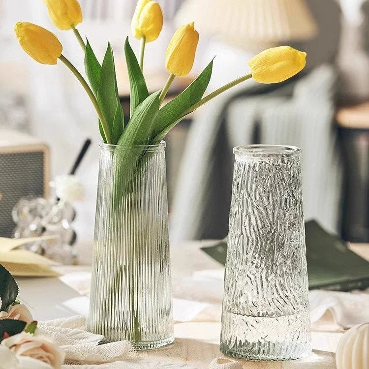 Large Ribbed Glass Vase with yellow tulips next to the Large Bark Textured Glass Vase on a styled table. - RoomDen