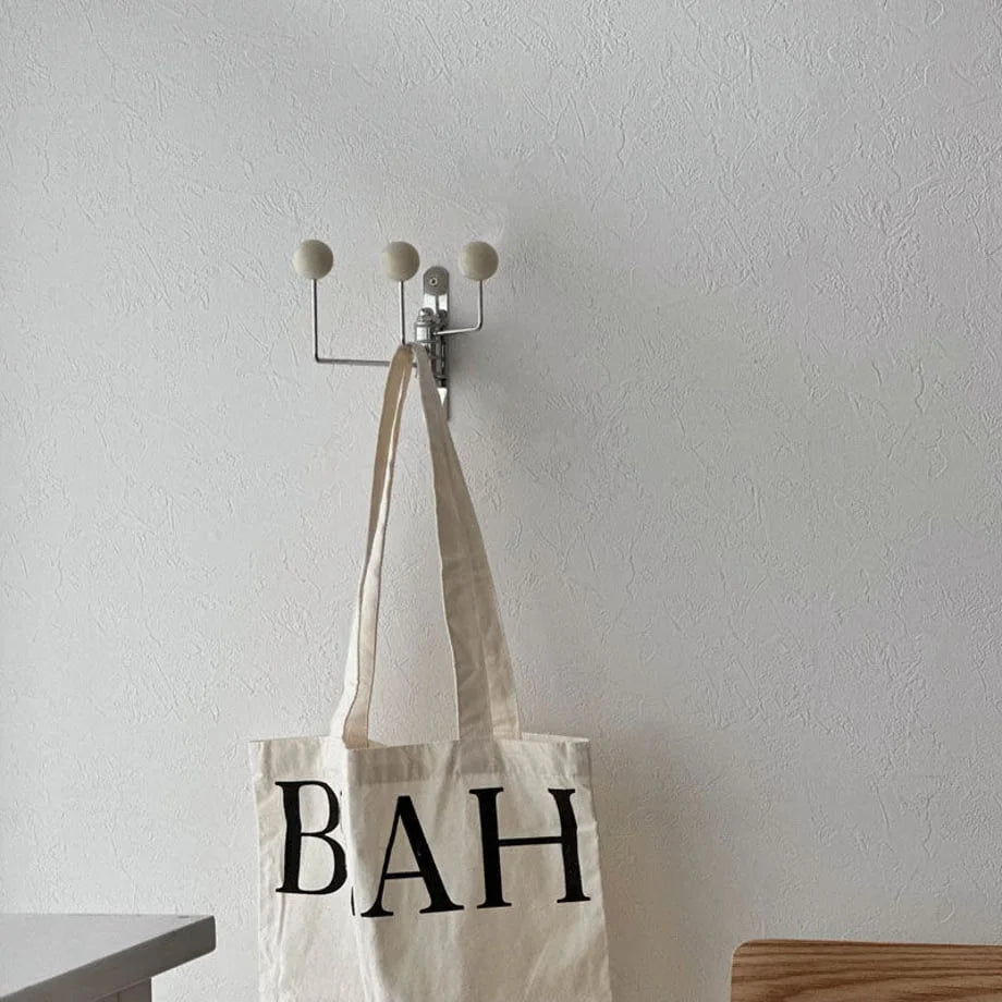 Lifestyle image featuring the cream swivel hook with a 'BAH' tote bag, showcasing its Japandi aesthetic - RoomDen.