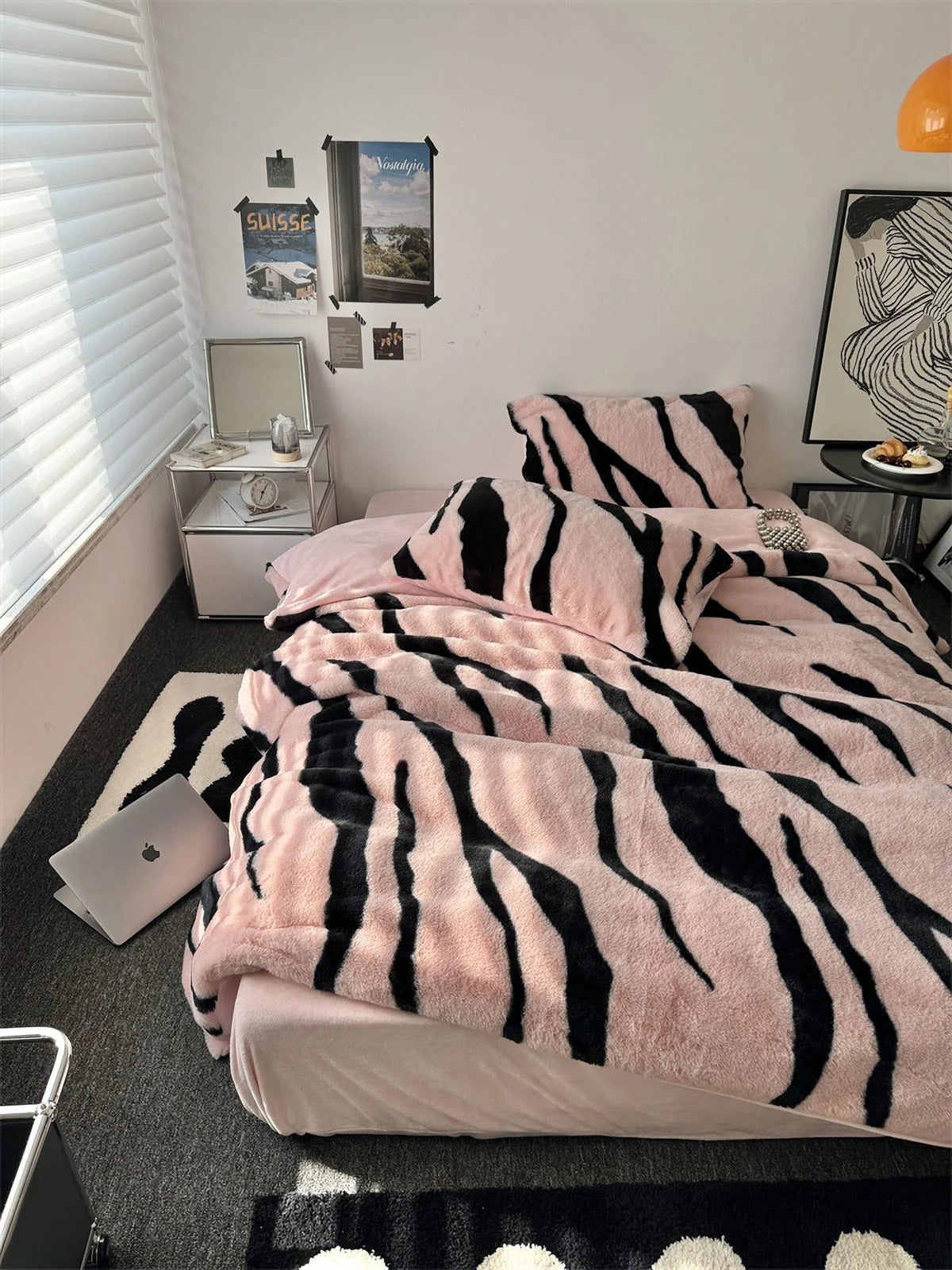 A full view of the Plush Tiger Stripe Fleece Bedding Set in Blush Pink, styled in a modern dorm room with a laptop on the floor. - RoomDen