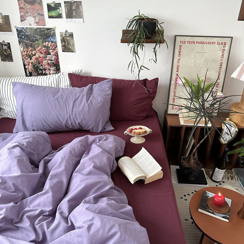 Thistle Plum Cotton Bedding Set – lilac and plum pillow arrangement above the duvet - Roomden