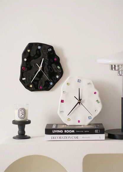 Wavy Jeweled Ceramic Clocks in black and white styled as wall decor above a stack of books - RoomDen