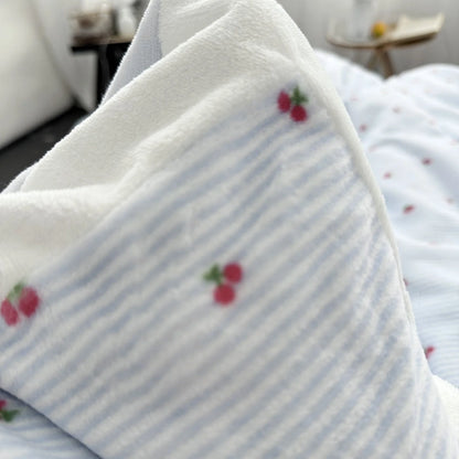 Detailed shot showing the soft, textured material of the flannel fleece bedding with its cute cherry pattern - RoomDen.