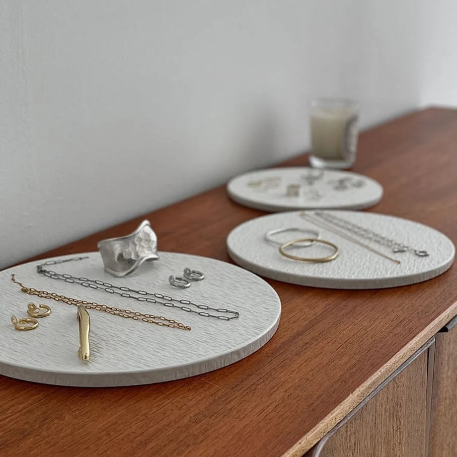 Close-up view of the Wabi-Sabi textured jewelry trays, highlighting the contrast between the ceramic and the jewelry. - RoomDen