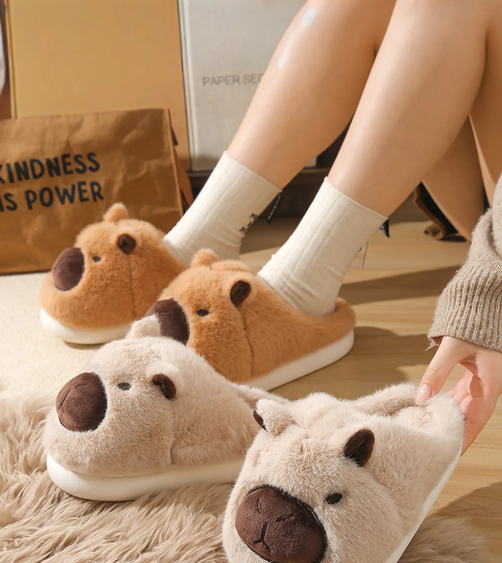 Collection of Brown Beige and Pink Capybara slippers with model legs RoomDen