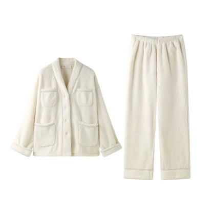 Flat lay of the cream flannel fleece pajama set, showing the button-up top and matching pants on a white background - RoomDen.