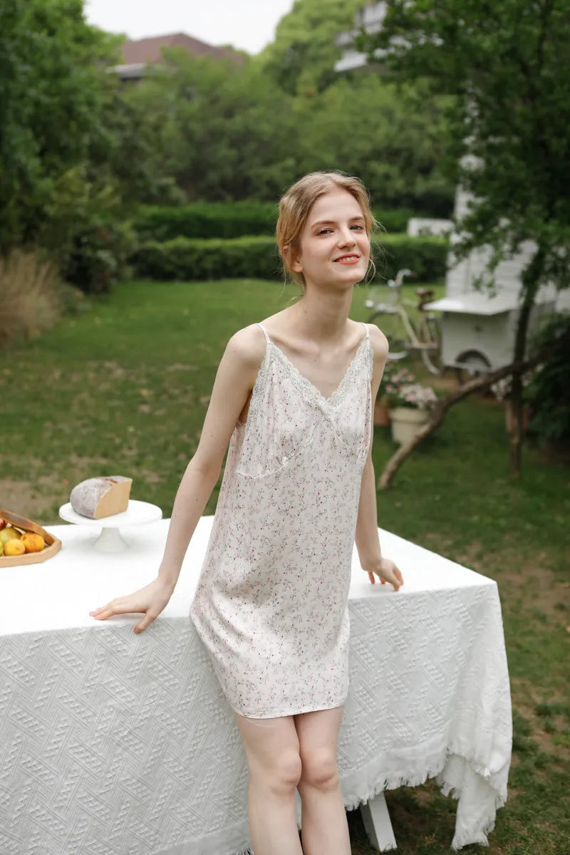 Model wearing cotton sateen floral nightgown in a cottagecore garden setting